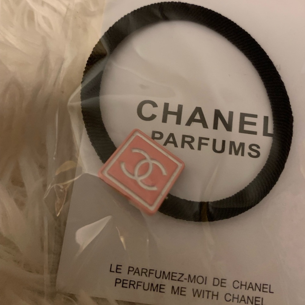 Chanel hair tie, with pink CC square.  The band is extra tight and will last!